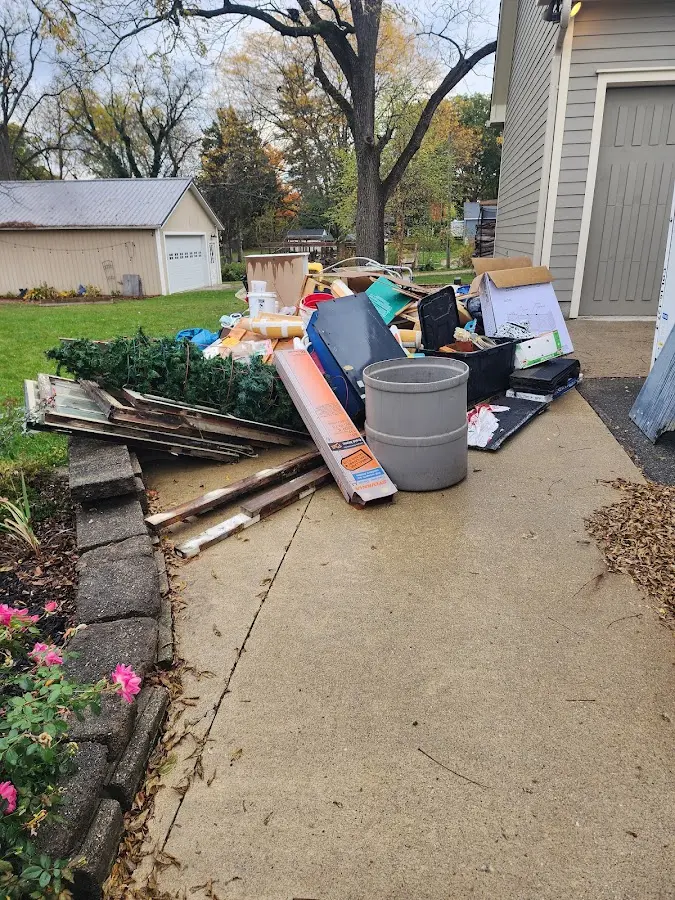 Dumpster being loaded with debris for 30 Yard Dumpster Rental in Lake Park
